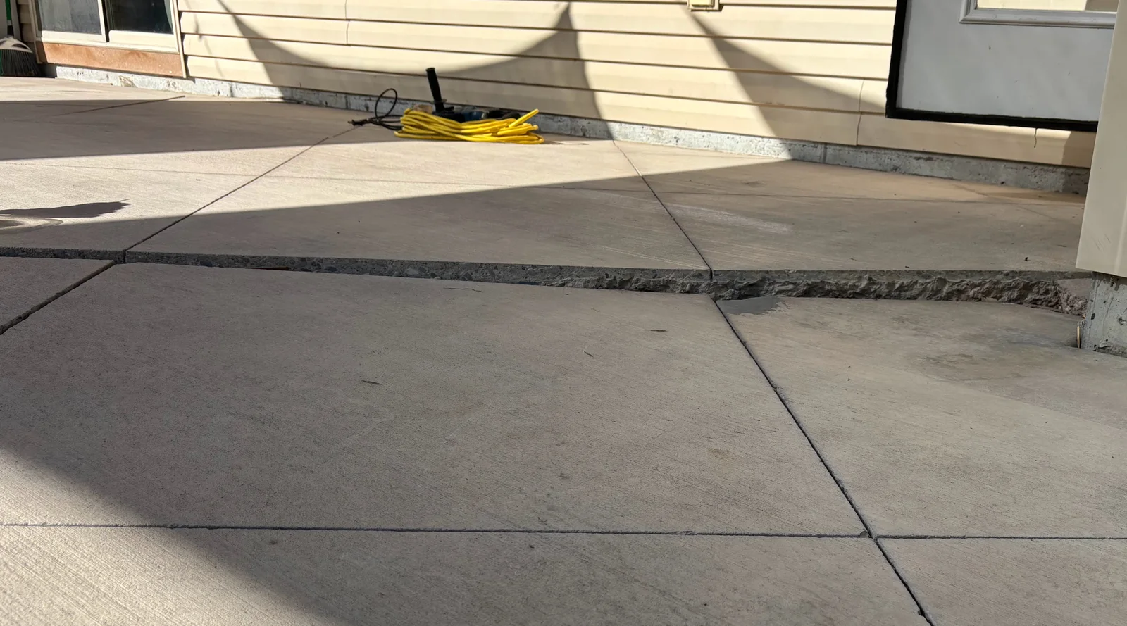 Sunken concrete patio panel beside a home