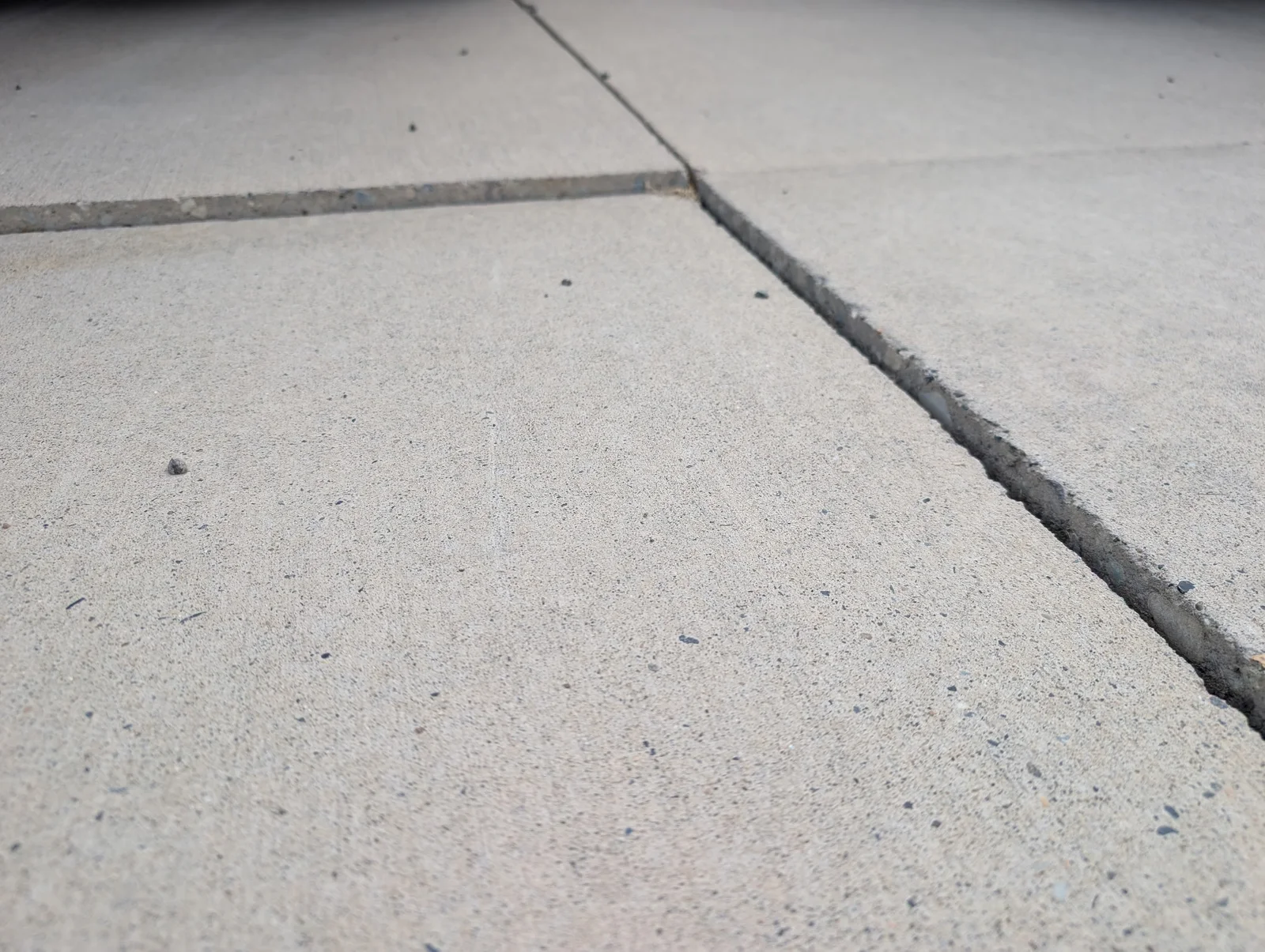 Sunken concrete panels meeting at an uneven joint